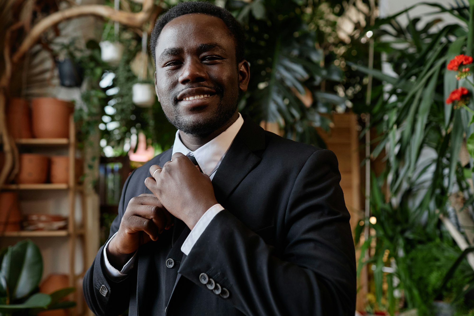 A black groom wearing a tuxedo that he rented from a local, independently owned formalwear store